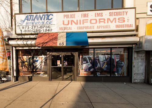 Storefront of the 65 Market Street Newark location, formerly Katzin's Uniforms, with police, fire, EMS and security uniform signage